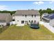Aerial view of backyard with a trampoline, fence, and sliding doors that lead to patio at 13315 Hunting Birds Ln, Charlotte, NC 28278