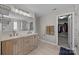 Luxurious bathroom featuring a double vanity, modern fixtures, and a separate walk-in closet for added convenience at 13315 Hunting Birds Ln, Charlotte, NC 28278