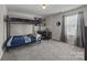 Comfortable bedroom with a bunk bed, neutral carpeting, and a window offering natural light for a cozy atmosphere at 13315 Hunting Birds Ln, Charlotte, NC 28278