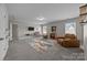 Spacious bonus room featuring plush gray carpeting, natural light, and a cozy seating area for relaxation and entertainment at 13315 Hunting Birds Ln, Charlotte, NC 28278