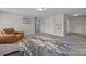 Large bonus room with a colorful rug features carpet flooring and ample space for seating and storage at 13315 Hunting Birds Ln, Charlotte, NC 28278