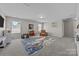 Spacious bonus room with neutral carpet offers versatility for play or relaxation, flooded with natural light at 13315 Hunting Birds Ln, Charlotte, NC 28278