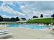 Large community pool with abundant seating and well-maintained surrounding landscaping at 13315 Hunting Birds Ln, Charlotte, NC 28278