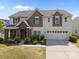 Charming two-story home featuring stone accents, neutral siding, and an attached two-car garage at 13315 Hunting Birds Ln, Charlotte, NC 28278