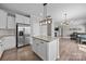 Open-concept kitchen features granite countertops, stainless steel appliances, and adjoins living area at 13315 Hunting Birds Ln, Charlotte, NC 28278
