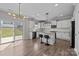 Bright, eat-in kitchen features granite countertops, island with breakfast bar, and sliding door to backyard at 13315 Hunting Birds Ln, Charlotte, NC 28278