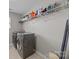 Functional laundry room with modern appliances, ample storage shelves, and neutral flooring for easy maintenance at 13315 Hunting Birds Ln, Charlotte, NC 28278