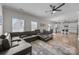 Open living space with a large sectional, hardwood floors, and seamless flow to the kitchen at 13315 Hunting Birds Ln, Charlotte, NC 28278