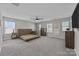 Bright main bedroom with large windows, ceiling fan, neutral carpeting, and ample space for a king-sized bed at 13315 Hunting Birds Ln, Charlotte, NC 28278