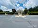 Community pool entrance featuring manicured landscaping and accessible parking spots at 13315 Hunting Birds Ln, Charlotte, NC 28278