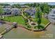 Aerial view of luxurious lakefront homes with swimming pools, piers, and beautifully landscaped yards at 135 Canoe Pole Ln, Mooresville, NC 28117