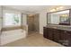 Bright bathroom featuring a walk-in shower and soaking tub at 135 Canoe Pole Ln, Mooresville, NC 28117