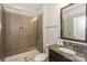 Bathroom featuring a glass shower, granite counters and sleek tile flooring at 135 Canoe Pole Ln, Mooresville, NC 28117