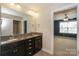 Bathroom featuring a double vanity with dark cabinetry and stone countertops at 135 Canoe Pole Ln, Mooresville, NC 28117