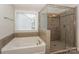 A close up shot of the walk-in shower and soaking tub in the bathroom at 135 Canoe Pole Ln, Mooresville, NC 28117