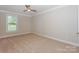 Clean, neutral bedroom featuring wall-to-wall carpet, a window, and ample natural light at 135 Canoe Pole Ln, Mooresville, NC 28117