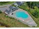 Aerial view of a large community pool with plenty of lounge chairs and a pool house at 135 Canoe Pole Ln, Mooresville, NC 28117