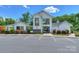 Exterior of the community pool building with a large parking lot and landscaped bushes at 135 Canoe Pole Ln, Mooresville, NC 28117
