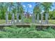 Entrance to the Lakewalk community featuring stone accents, professional landscaping, and scenic greenery at 135 Canoe Pole Ln, Mooresville, NC 28117