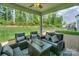 Charming, covered brick patio features a comfortable outdoor seating area and views of the backyard at 135 Canoe Pole Ln, Mooresville, NC 28117
