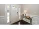 Elegant entryway with a white door, wood floors, mirrored table, and wainscoting at 135 Canoe Pole Ln, Mooresville, NC 28117