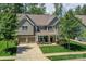 Charming two-story home with a two-car garage, landscaped front yard and inviting front porch at 135 Canoe Pole Ln, Mooresville, NC 28117