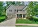 Charming two-story home with manicured lawn, two-car garage, and inviting front porch at 135 Canoe Pole Ln, Mooresville, NC 28117