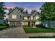 Beautiful two-story home featuring a well-lit exterior, manicured lawn, and inviting front porch at 135 Canoe Pole Ln, Mooresville, NC 28117