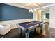 Game room featuring a pool table, dark wood floors, and a view into another room at 135 Canoe Pole Ln, Mooresville, NC 28117