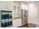 Well-equipped kitchen with stainless steel appliances, granite countertops, and white cabinets at 135 Canoe Pole Ln, Mooresville, NC 28117