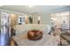 Inviting living room featuring an oversized ottoman and a white sectional sofa at 135 Canoe Pole Ln, Mooresville, NC 28117
