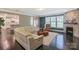 Comfortable living room with a stone fireplace and large windows for ample natural light at 135 Canoe Pole Ln, Mooresville, NC 28117