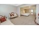 The main bedroom features carpet floors, a seating area and neutral paint at 135 Canoe Pole Ln, Mooresville, NC 28117