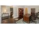 A home office featuring a wooden desk, bookshelves, and dark wood floors at 135 Canoe Pole Ln, Mooresville, NC 28117
