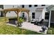 Backyard patio with hot tub, grill, furniture set and pergola on a paver patio with landscaping at 154 Cotton Field Dr, Statesville, NC 28677