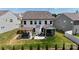 Exterior shot showcasing backyard with a hot tub, patio furniture, covered porch, and landscaping at 154 Cotton Field Dr, Statesville, NC 28677