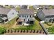 Aerial view of a backyard with a hot tub, patio furniture, screened in porch, and lush green lawn at 154 Cotton Field Dr, Statesville, NC 28677