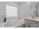 Bright bathroom featuring a large soaking tub with tile surround and elegant fixtures at 154 Cotton Field Dr, Statesville, NC 28677