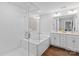 Bright bathroom with white tile, soaking tub, glass shower, and double vanity at 154 Cotton Field Dr, Statesville, NC 28677