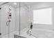 Bright bathroom featuring a soaking tub, glass shower, and neutral-toned tile at 154 Cotton Field Dr, Statesville, NC 28677