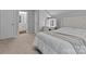 Bedroom featuring neutral carpet and decor, a lighted vanity, and ensuite access, making it a perfect retreat at 154 Cotton Field Dr, Statesville, NC 28677