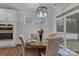 Cozy dining area with modern lighting, complemented by a view of the screened in porch at 154 Cotton Field Dr, Statesville, NC 28677