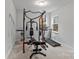 Home exercise room equipped with a weight machine, treadmill, and natural light from the windows at 154 Cotton Field Dr, Statesville, NC 28677