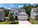 Inviting two-story home with a well-manicured lawn, two car garage, and a classic white exterior at 154 Cotton Field Dr, Statesville, NC 28677