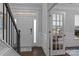 Elegant foyer with hardwood floors, staircase with dark railings, and ample natural light at 154 Cotton Field Dr, Statesville, NC 28677