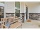 Inviting front porch with stone accents, a cozy bench, and a welcoming entrance at 154 Cotton Field Dr, Statesville, NC 28677