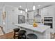 Modern kitchen featuring white cabinets, stainless steel appliances, and a spacious island with stool seating at 154 Cotton Field Dr, Statesville, NC 28677