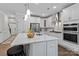Spacious kitchen featuring white cabinets, stainless steel appliances, and a large center island with seating at 154 Cotton Field Dr, Statesville, NC 28677