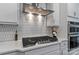 Close-up of a modern kitchen showcasing stainless steel appliances and stylish range hood at 154 Cotton Field Dr, Statesville, NC 28677