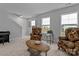 Bright living room with chairs, coffee table, piano, staircase and windows at 154 Cotton Field Dr, Statesville, NC 28677